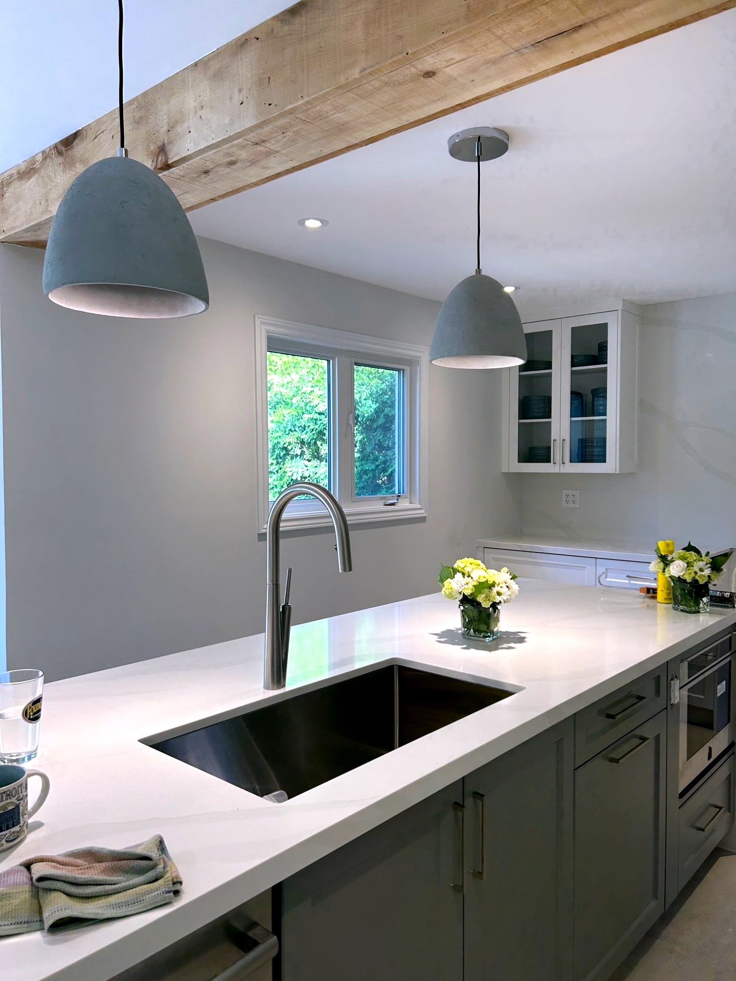 Custom grey kitchen with beam pendant lighting