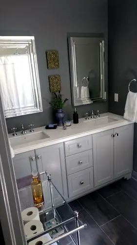 Light grey painted Shaker double vanity with white quartz counter, undermount sinks, brushed-nickel square knobs and pulls, chrome cross-handle faucets and framed mirrors against a charcoal wall — custom vanity hand-built by Classic Woodworking & Vanity in Oakville, Ontario