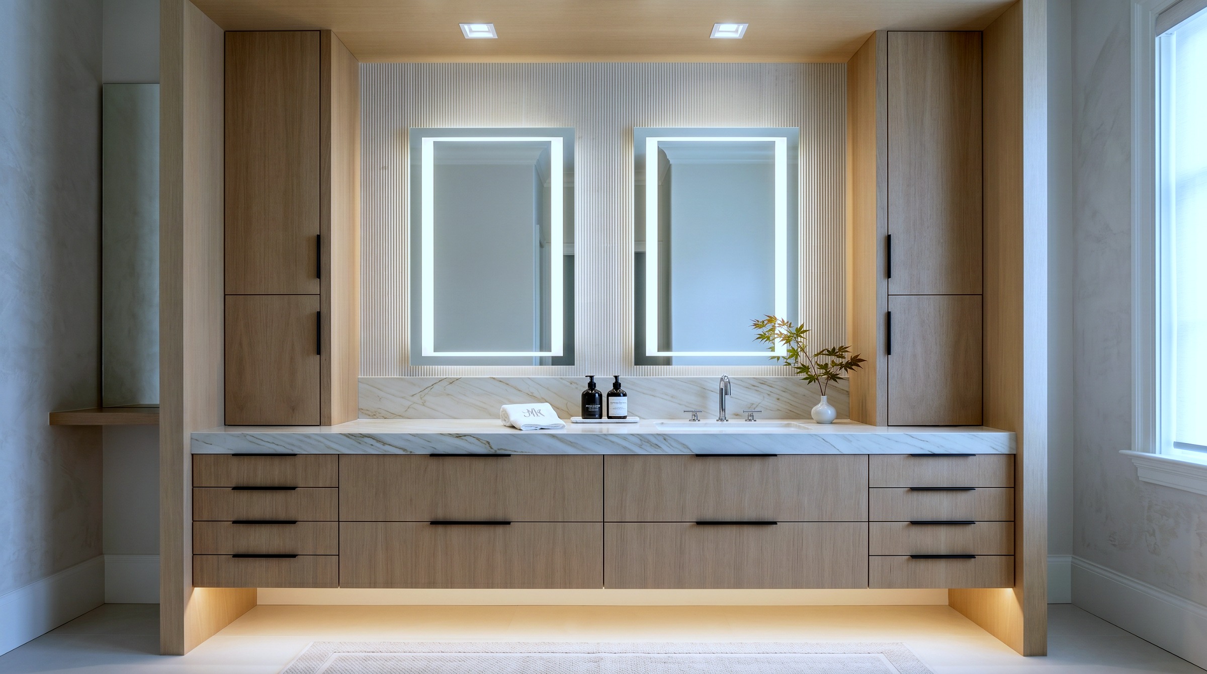 Oak floating double vanity with backlit fluted detailing